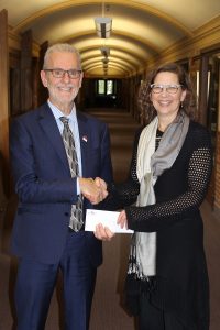 Ted Fransen presents a cheque to CMU President Dr. Cheryl Pauls