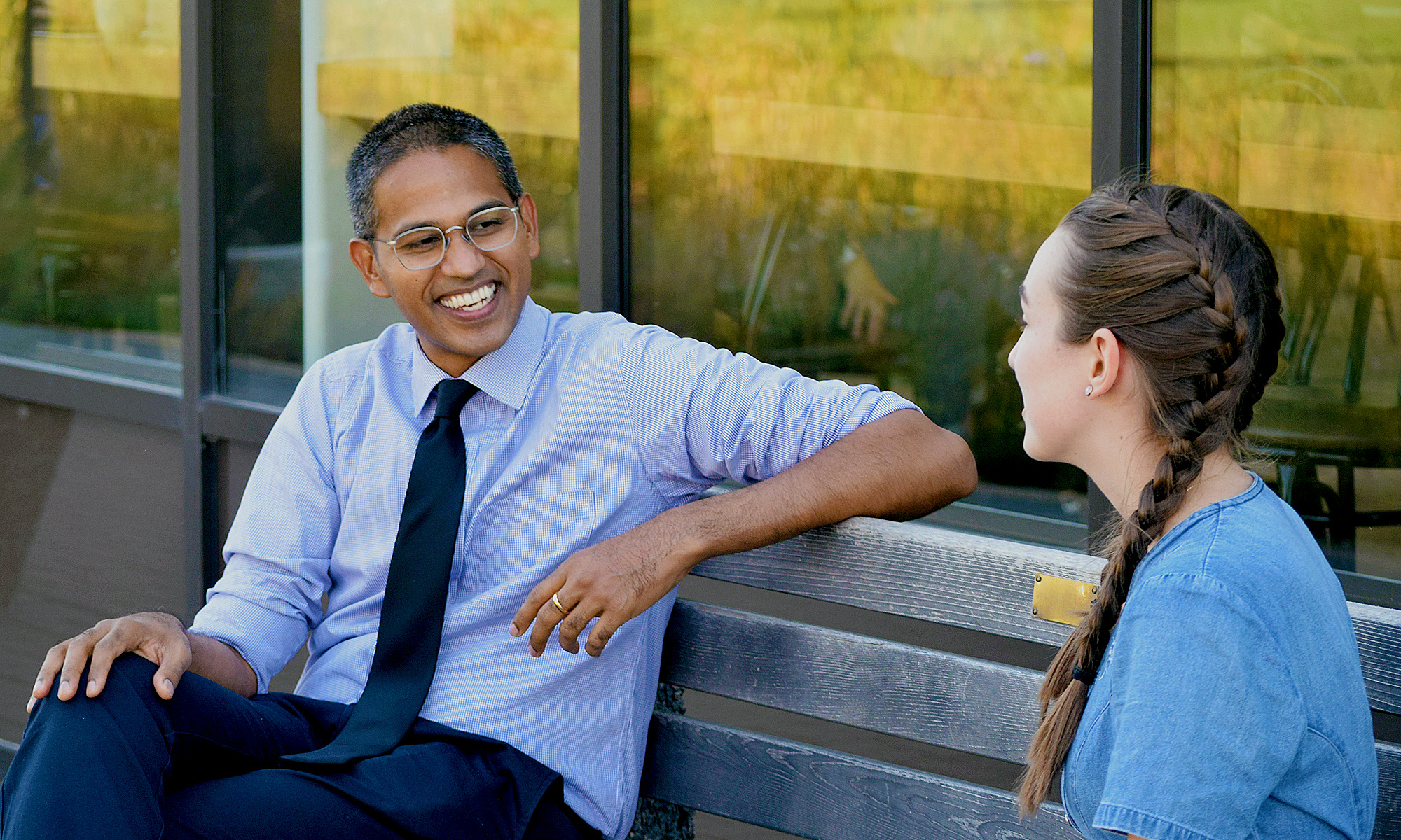 CMU Professor John Boopalan smiling while talking to a student