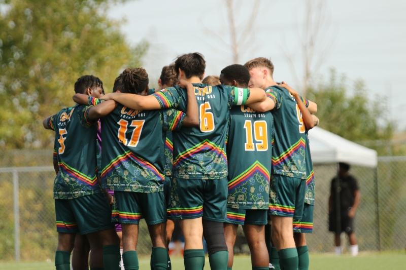 The 2024-25 Men's soccer team huddles up before their home opener last September