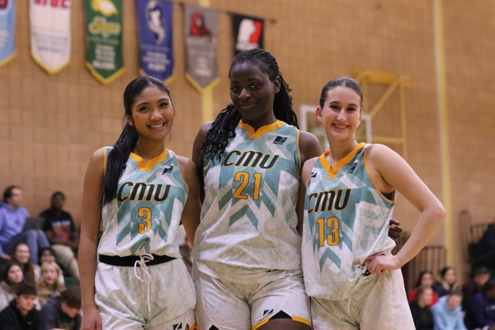 Gbadamosi (centre) and teammates Reyna Reyes and Anna Pyne are all smiles during their last game with the Providence Pilots.