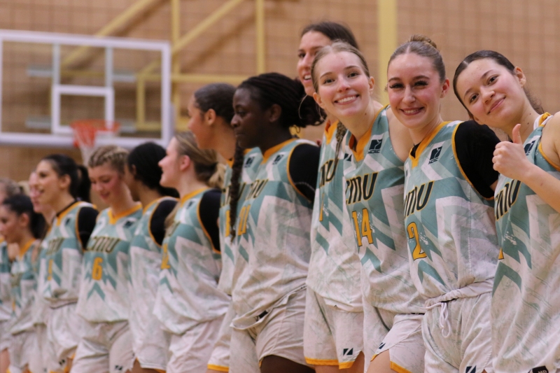Blazers WBB members await their medals after recapturing the MCAC Championship title this past March
