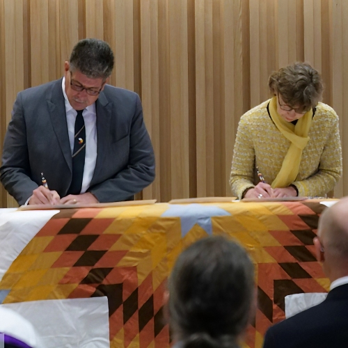 CMU President Cheryl Pauls (right) signs the 2023 Manitoba Collaborative Indigenous Education Blueprint, a recommitment to to helping Indigenous people succeed in all levels of Manitoba’s education system.