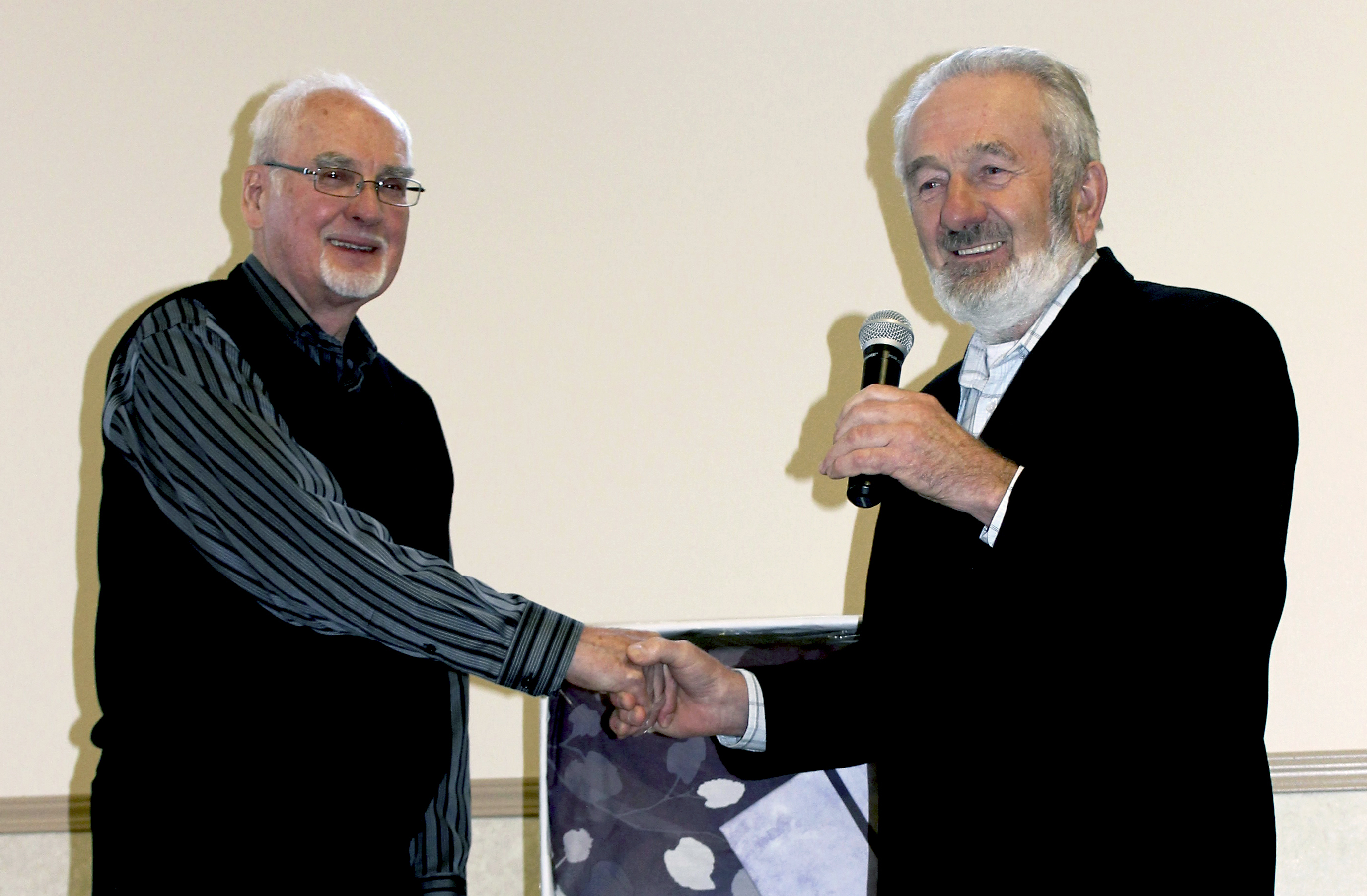 Arnold Hofer (right), pastor of the Acadia Hutterite Community, thanks Dr. John J. Friesen.