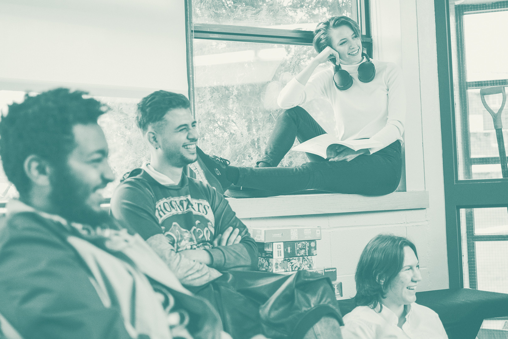 students laugh together in a dorm common space