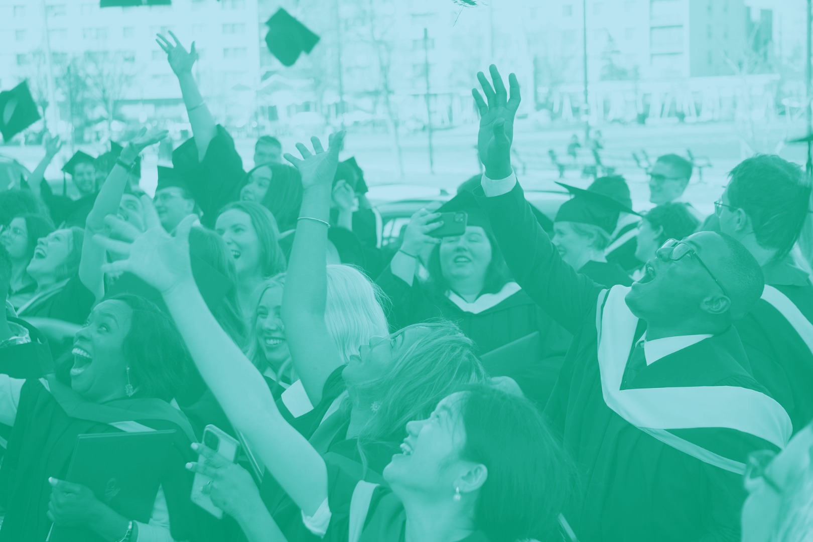 New grads toss their caps in the air