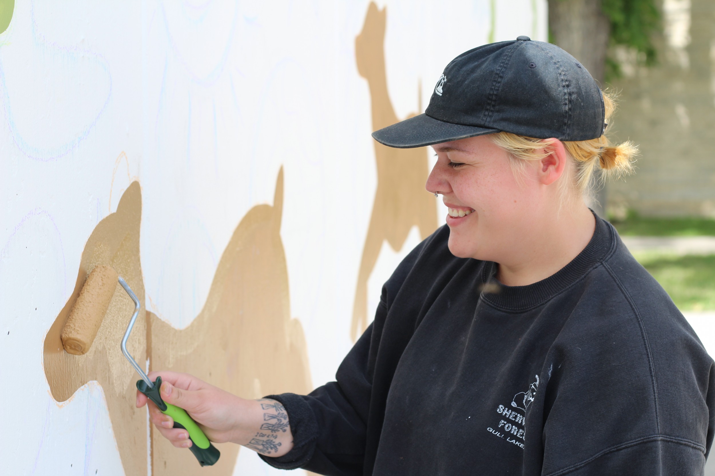 Student painting mural on CMU campus