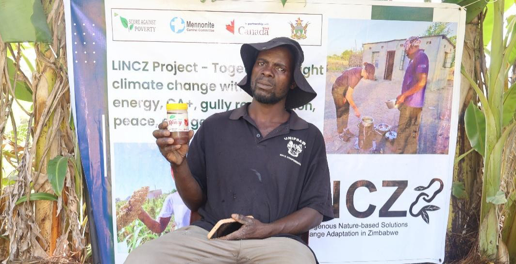 Simon Mazazate from Mwenezi, Zimbabwe holding a honey bottle, Score Against Poverty, 2026 