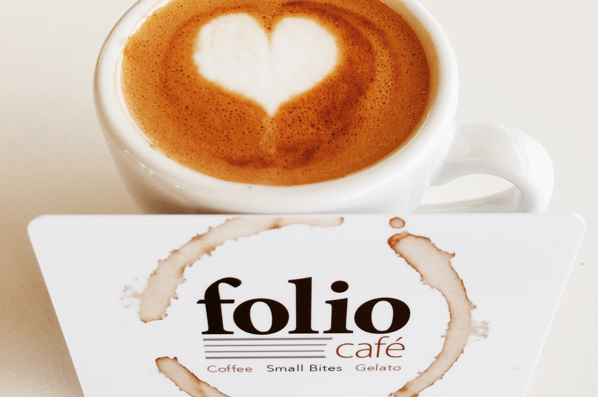 folio café gift card next to a cup of coffee