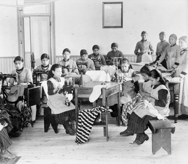 Old black and white picture of Indian residential school in Northwest Territories, young children learning