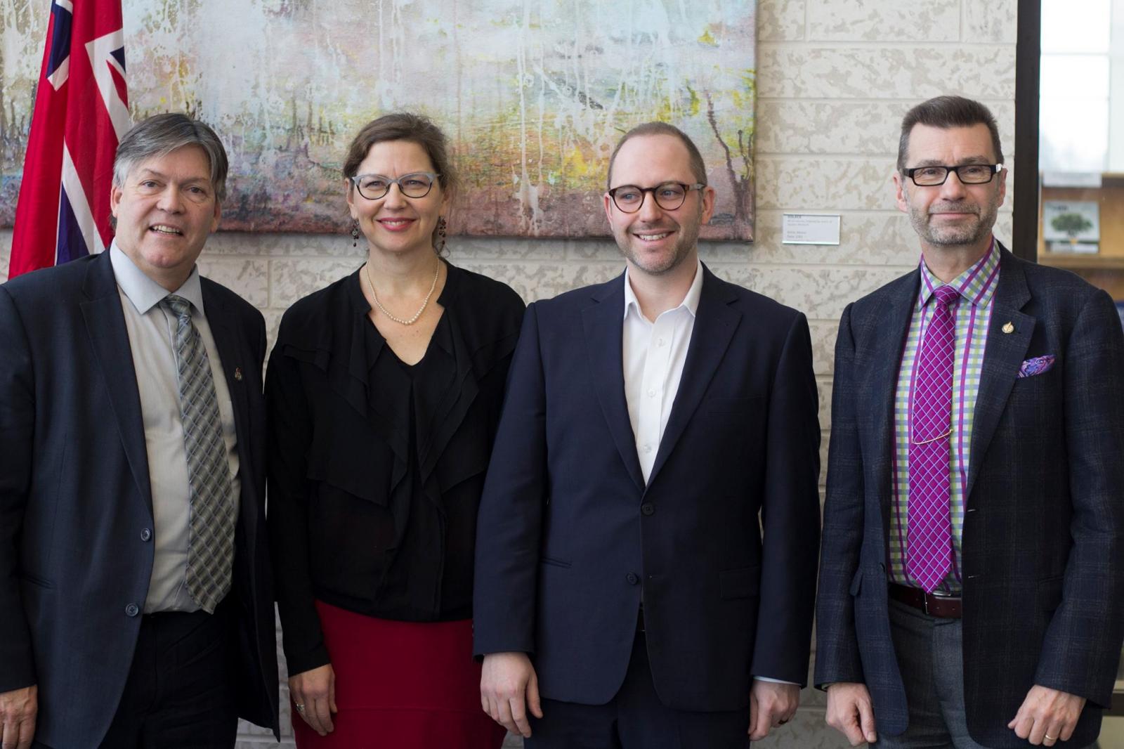 CMU President Cheryl Pauls and CFR Director James Magnus-Johnston are joined by Ian Wishart, Manitoba's Minister of Education (left) and Doug Eyolfson, MP for Charleswood-St. James-Assiniboia-Headingley (right).