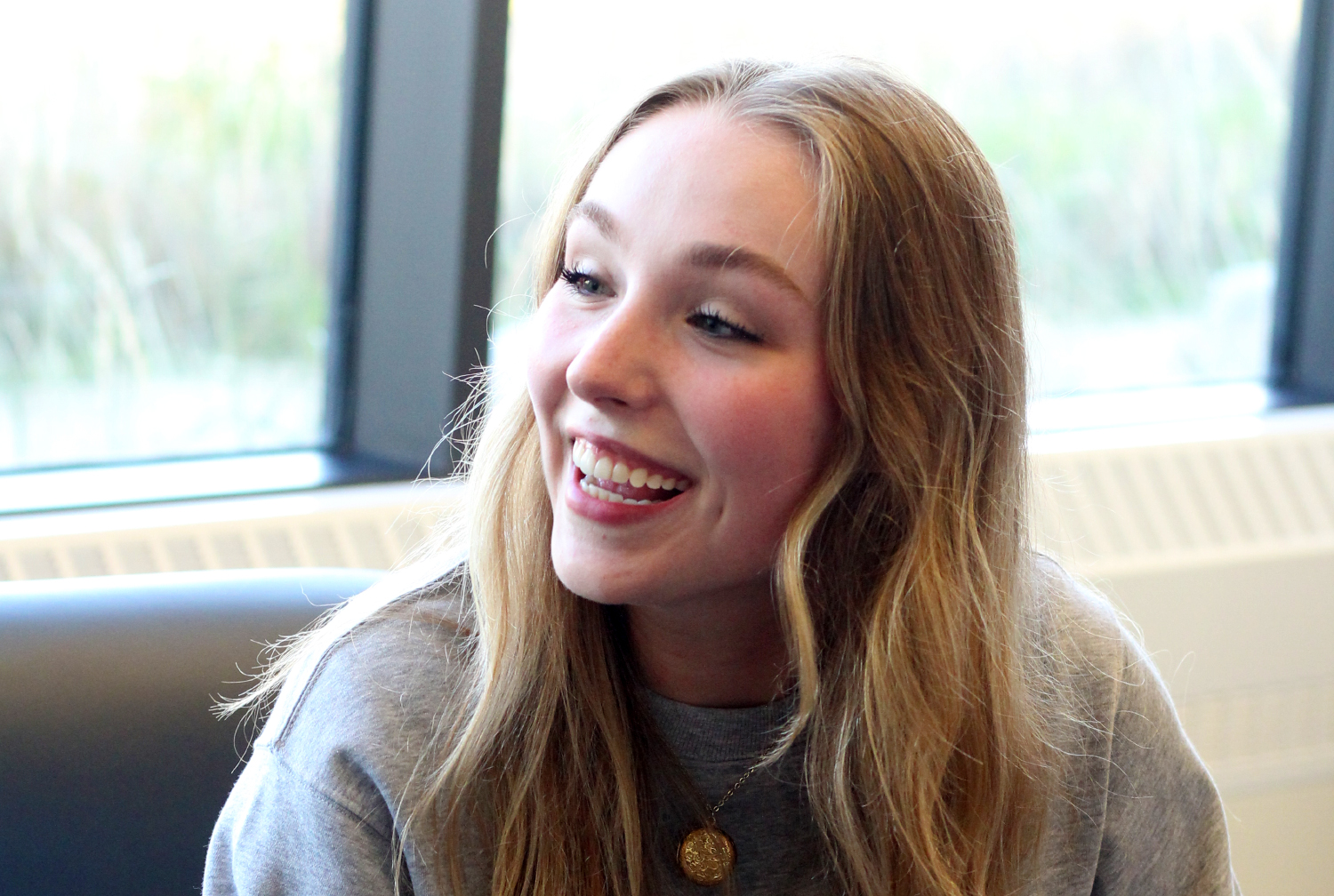 a woman smiles while in conversation