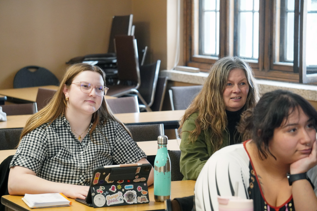 A group of students sit in a Social Work class