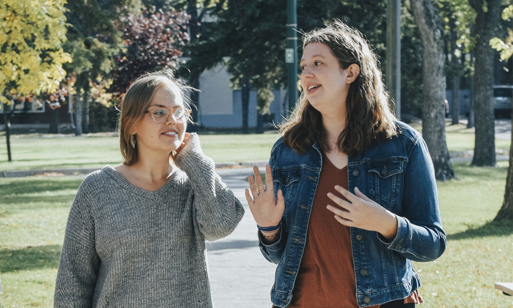 students walking together outside on campus