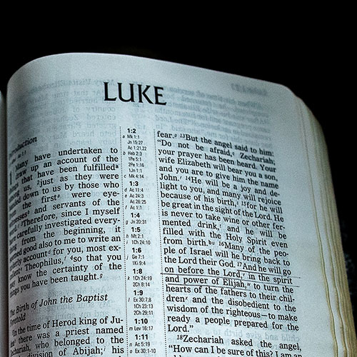 A Bible open to the first chapter of Luke